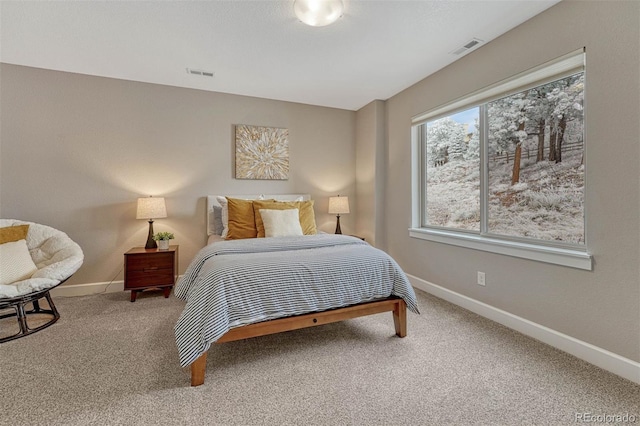 bedroom with baseboards, visible vents, and carpet flooring