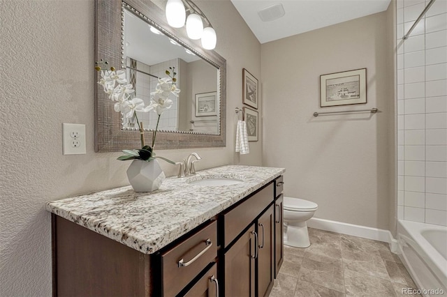 bathroom featuring baseboards, vanity, and toilet