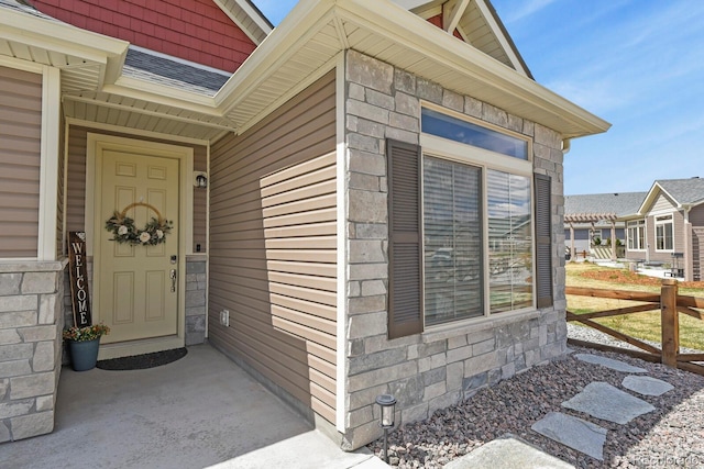 doorway to property with stone siding