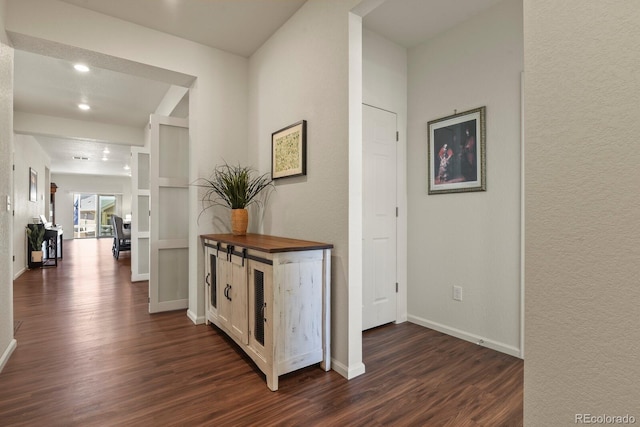 hallway with recessed lighting, baseboards, and dark wood-style floors