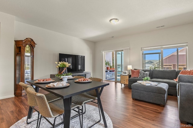 dining room featuring baseboards and dark wood-style flooring
