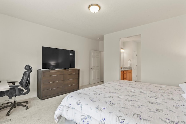 bedroom with connected bathroom, carpet floors, and baseboards