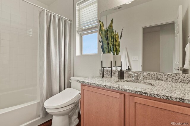 full bathroom with shower / tub combo, toilet, vanity, and visible vents