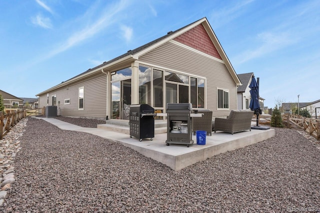 rear view of property featuring central air condition unit, a patio area, a fenced backyard, and an outdoor living space