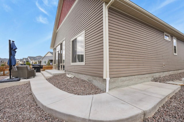 view of side of home with a patio and an outdoor hangout area