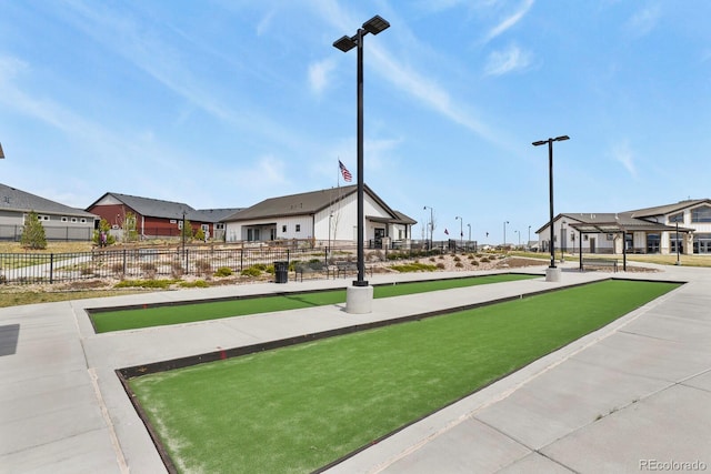 view of property's community with fence and a residential view