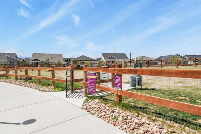 view of jungle gym with central AC unit, fence, and a residential view