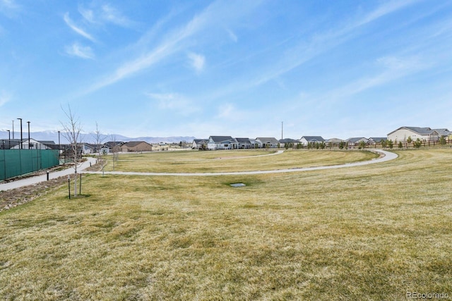 view of yard featuring fence and a residential view