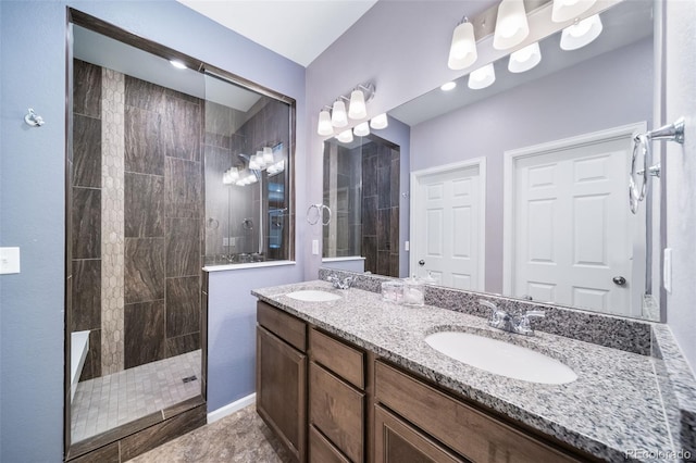 bathroom with vanity and tiled shower