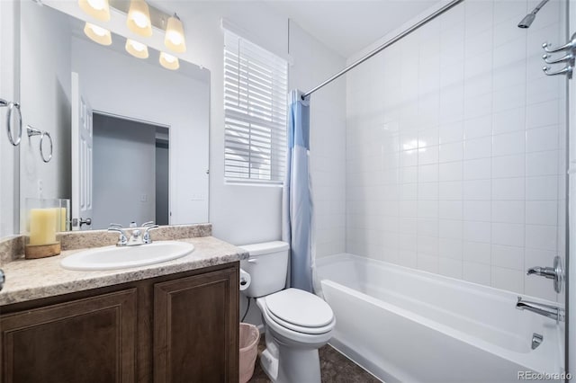 full bathroom featuring tiled shower / bath combo, vanity, and toilet