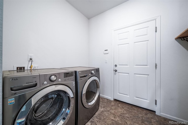 clothes washing area featuring washer and dryer