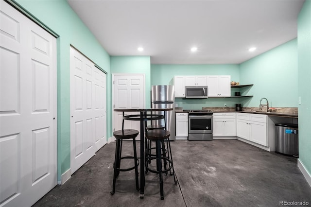 kitchen featuring white cabinetry, stainless steel appliances, and sink