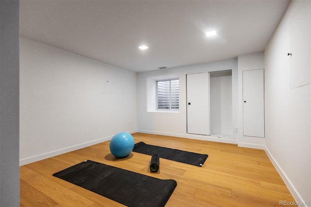 workout room with wood-type flooring