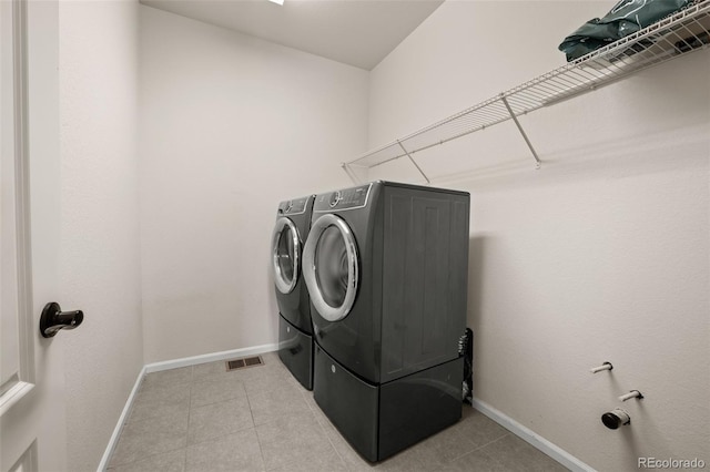 6514 Agave Ave, Castle Rock, CO 80108 - clothes washing area featuring laundry area, light tile patterned floors, baseboards, and washing machine and dryer