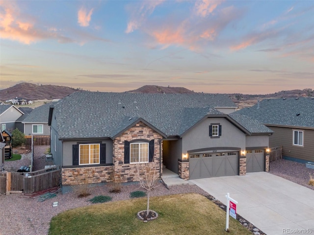 6514 Agave Ave, Castle Rock, CO 80108 - view of front facade with fence, concrete driveway, stucco siding, and stone siding