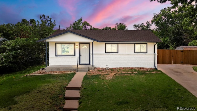 871 S Worchester St, Aurora, CO 80012 - view of front of house featuring brick siding, a gate, and roof with shingles