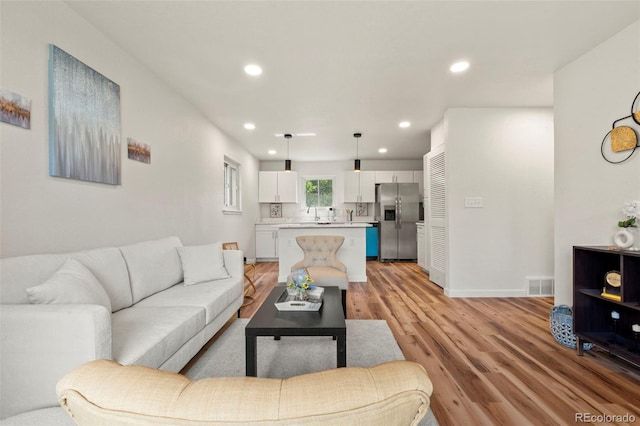 871 S Worchester St, Aurora, CO 80012 - living room with light wood-style flooring and recessed lighting