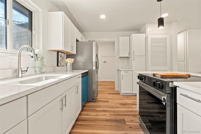 871 S Worchester St, Aurora, CO 80012 - kitchen with electric range, white cabinetry, light countertops, light wood finished floors, and dishwashing machine