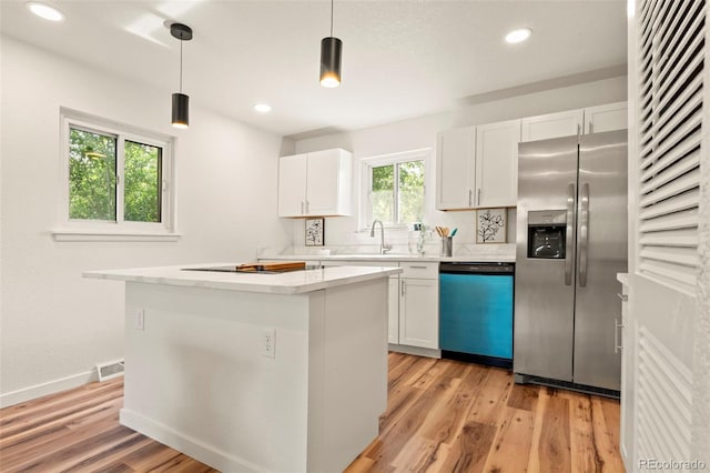 871 S Worchester St, Aurora, CO 80012 - kitchen with dishwasher, stainless steel fridge with ice dispenser, white cabinets, a kitchen island, and recessed lighting