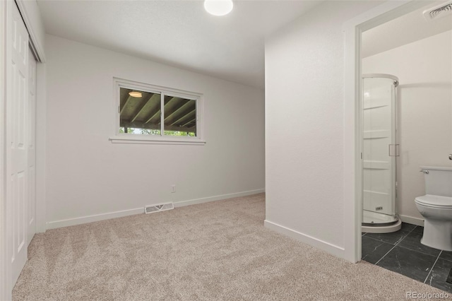 871 S Worchester St, Aurora, CO 80012 - unfurnished bedroom featuring dark colored carpet, a closet, and ensuite bath
