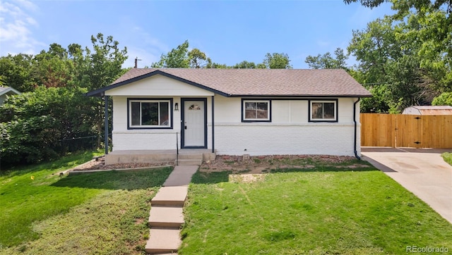 871 S Worchester St, Aurora, CO 80012 - view of front facade featuring brick siding, a gate, and a shingled roof