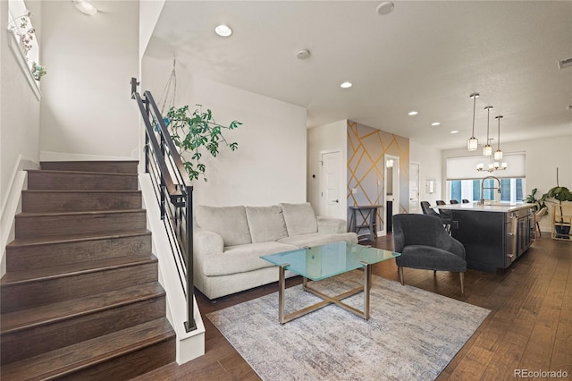 living area featuring stairway, recessed lighting, a chandelier, dark wood finished floors, and visible vents