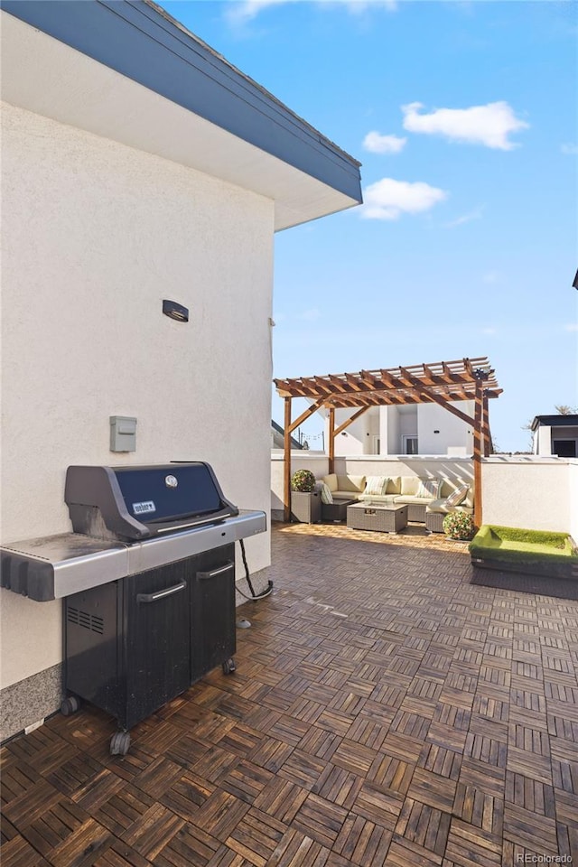 view of patio featuring area for grilling and a pergola