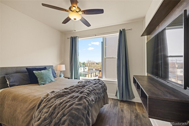 bedroom featuring baseboards, ceiling fan, and wood finished floors