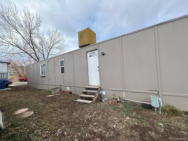 back of property with crawl space and entry steps