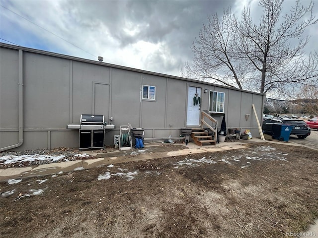 rear view of property featuring entry steps