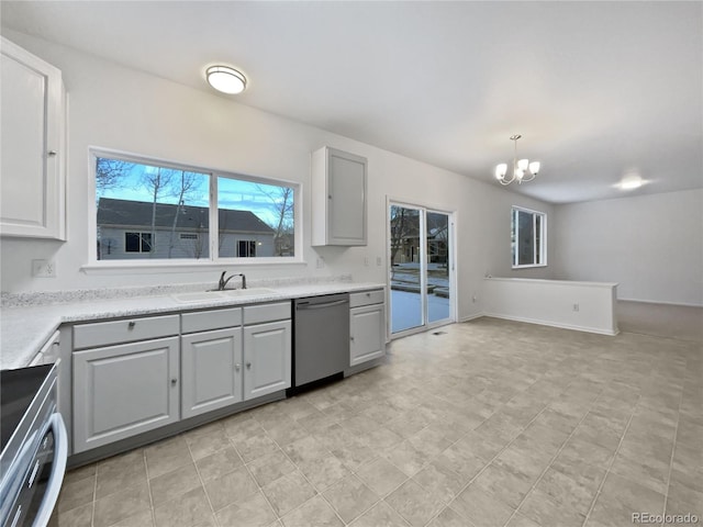 kitchen featuring pendant lighting, gray cabinetry, a sink, and stainless steel dishwasher