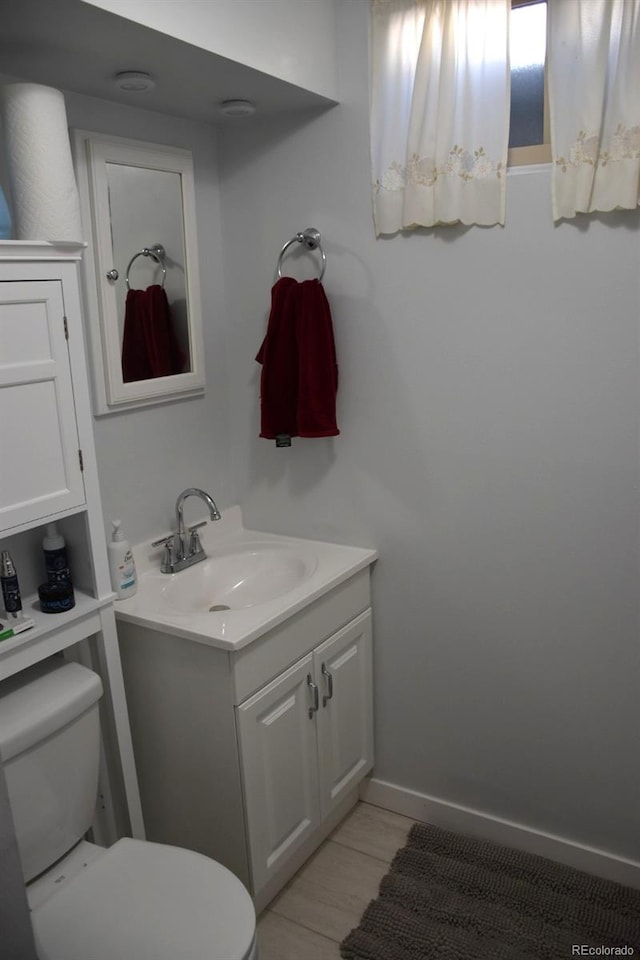 bathroom featuring toilet and vanity