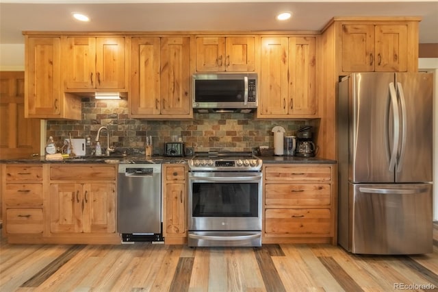 220 Rapids Ln Unit 4, Grand Lake, CO 80447 - kitchen featuring appliances with stainless steel finishes, a sink, light wood-style floors, decorative backsplash, and recessed lighting