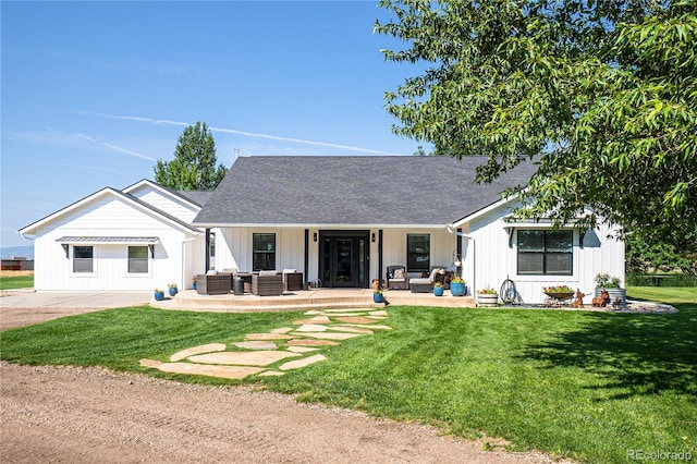 back of property with a yard and an outdoor hangout area