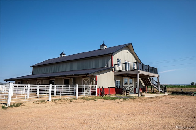 rear view of house with an outdoor structure