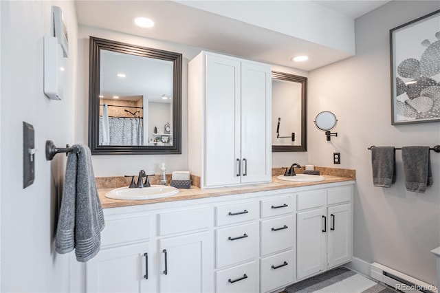 bathroom featuring curtained shower, a baseboard heating unit, and vanity