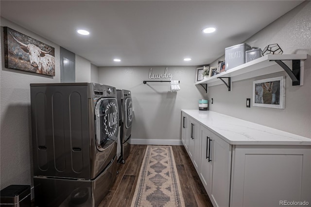 clothes washing area with cabinets and washer and dryer