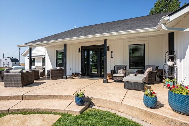 rear view of house with a shed, outdoor lounge area, and a patio