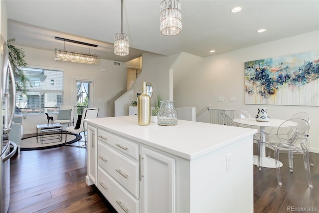 9180 E 52nd Dr, Denver, CO 80238 - kitchen with dark wood-type flooring, recessed lighting, white cabinetry, a center island, and hanging light fixtures