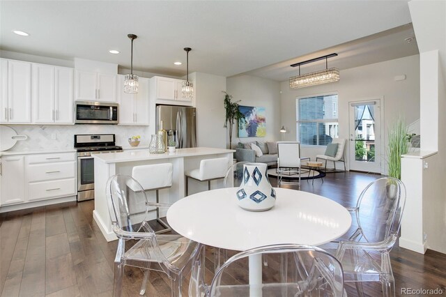 9180 E 52nd Dr, Denver, CO 80238 - dining space with dark wood-type flooring and recessed lighting