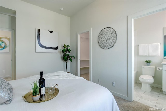 9180 E 52nd Dr, Denver, CO 80238 - bedroom featuring a spacious closet, connected bathroom, and a closet