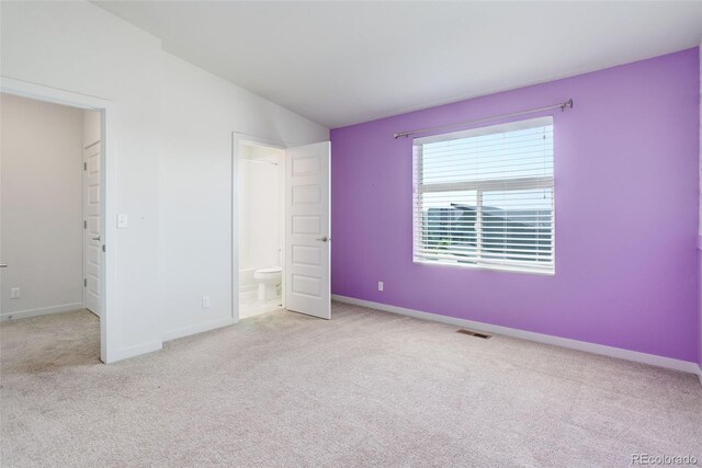 9180 E 52nd Dr, Denver, CO 80238 - unfurnished bedroom featuring carpet, connected bathroom, and lofted ceiling