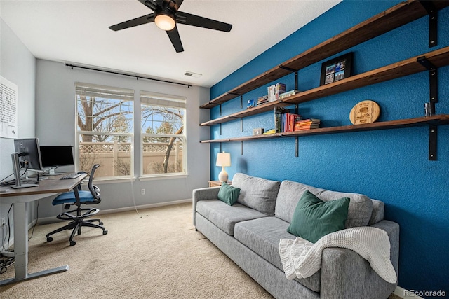 carpeted office with ceiling fan and plenty of natural light