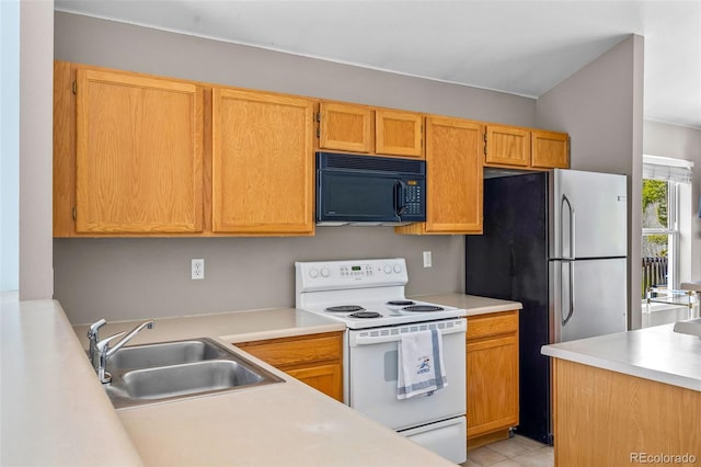 10 River Park Dr Unit A, Breckenridge, CO 80424 - kitchen with electric stove, black microwave, a sink, freestanding refrigerator, and light countertops
