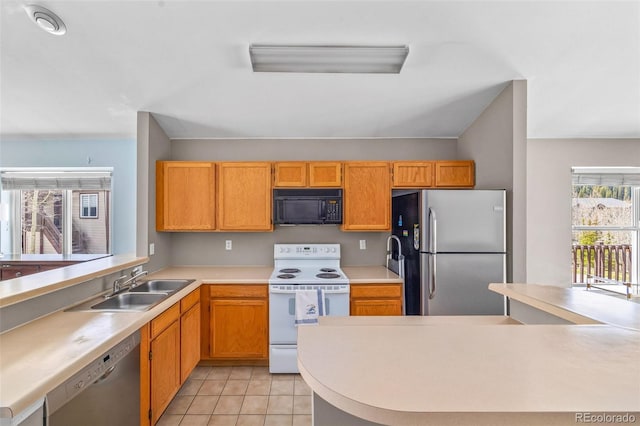 10 River Park Dr Unit A, Breckenridge, CO 80424 - kitchen with stainless steel appliances, light countertops, a sink, and light tile patterned flooring