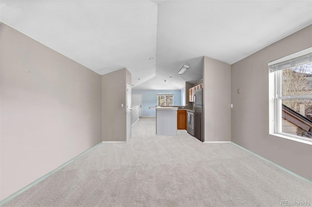 10 River Park Dr Unit A, Breckenridge, CO 80424 - unfurnished living room with lofted ceiling, healthy amount of natural light, light carpet, and baseboards