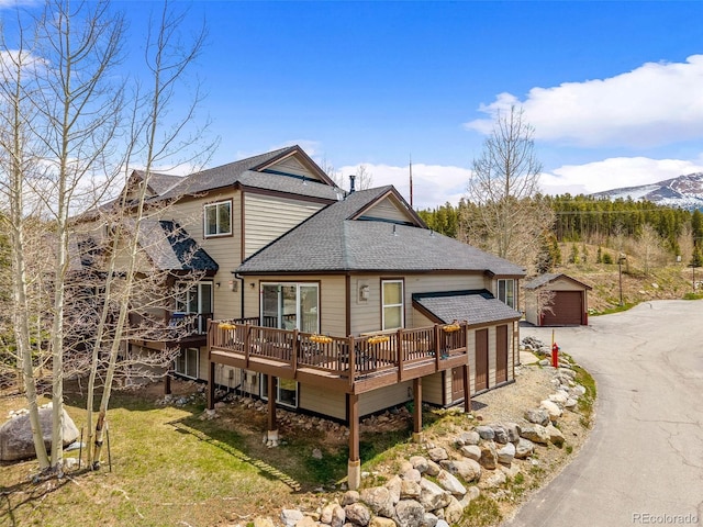 10 River Park Dr Unit A, Breckenridge, CO 80424 - back of house with roof with shingles, an outdoor structure, a deck with mountain view, and a detached garage