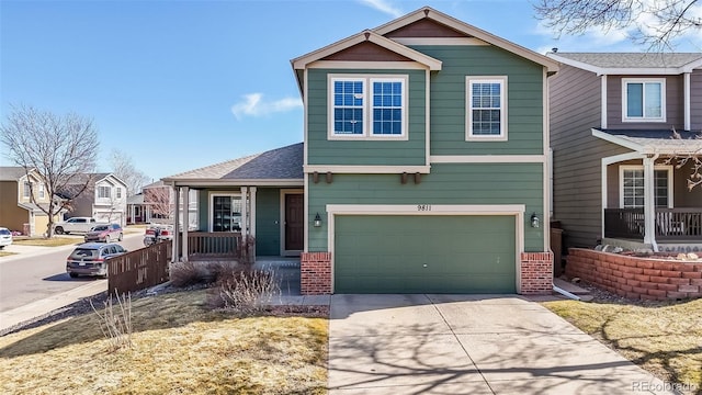 view of front of house with brick siding, a porch, an attached garage, and driveway