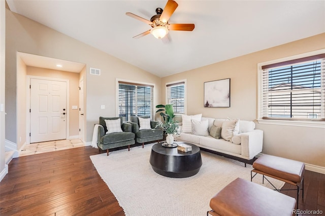 living room with vaulted ceiling, visible vents, ceiling fan, and hardwood / wood-style floors