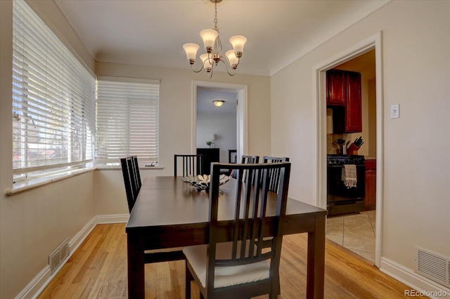 dining space featuring a chandelier and light hardwood / wood-style floors